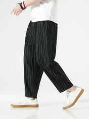 Men's black relaxed fit sweatpants with white pinstripes and a drawstring waist.