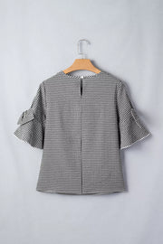 Black and white gingham polyester shirt with ruffled sleeves and a keyhole back detail.