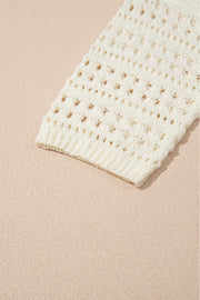Beige openwork knit beach cover-up with ribbed cuff detail.