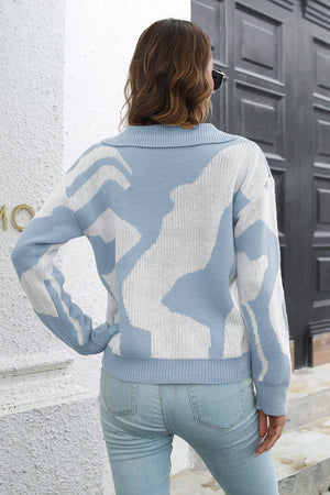 Women's light blue acrylic knit polo sweater with abstract white print.