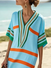 Striped half sleeve midi dress in pastel blue with orange and green stripes.