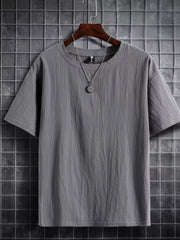 Grey cotton crew neck t-shirt with textured fabric and short sleeves.