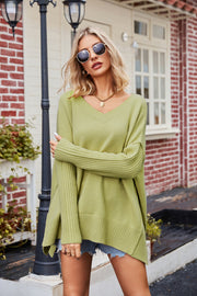 Lime v-neck knit sweater with asymmetric slit hemline and ribbed cuffs.