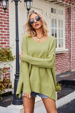 Lime v-neck knit sweater with asymmetric slit hemline and ribbed cuffs.