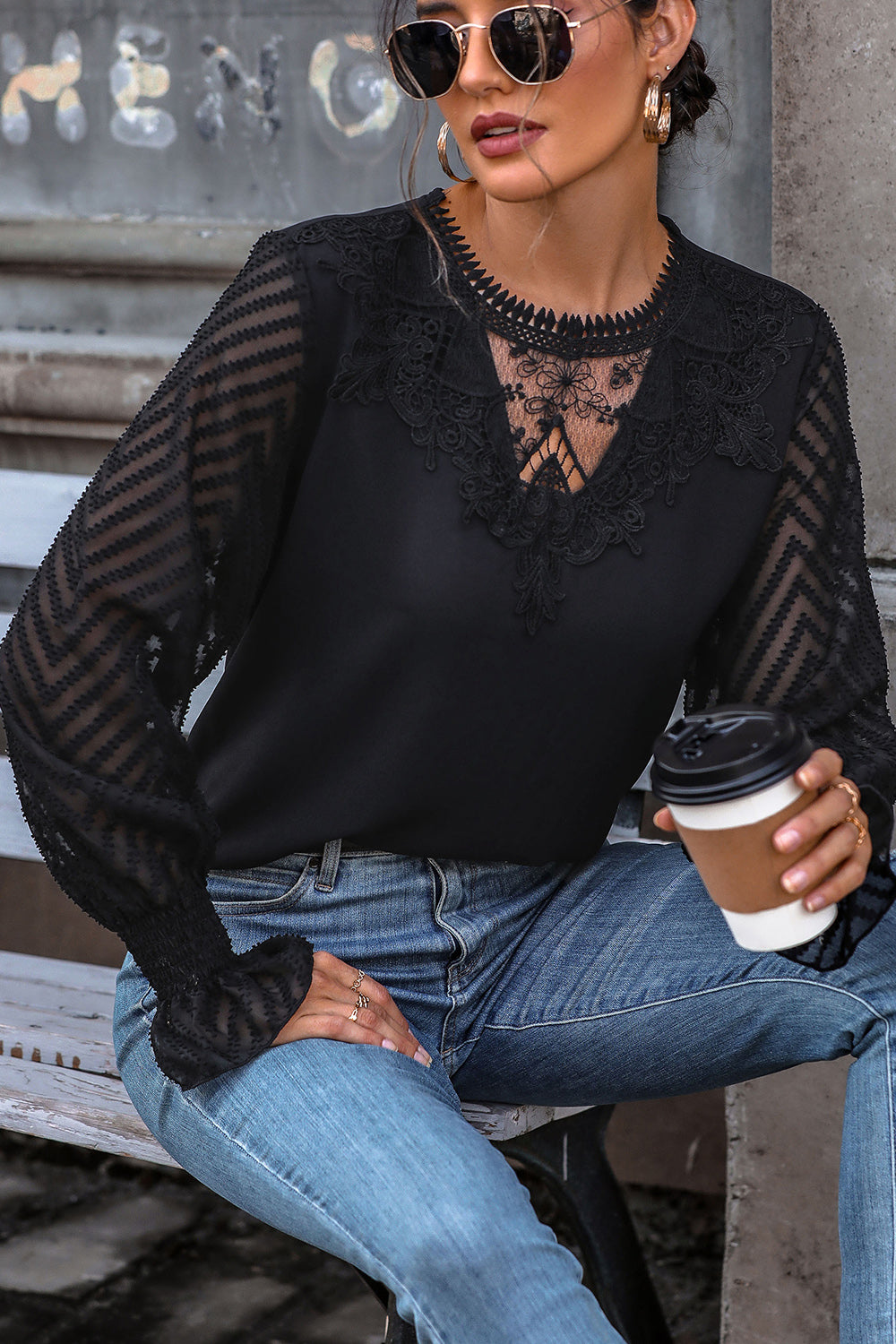 Black lace inset sheer sleeve blouse with chevron pattern on sleeves and V-neck detail.