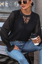 Black lace inset sheer sleeve blouse with chevron pattern on sleeves and V-neck detail.