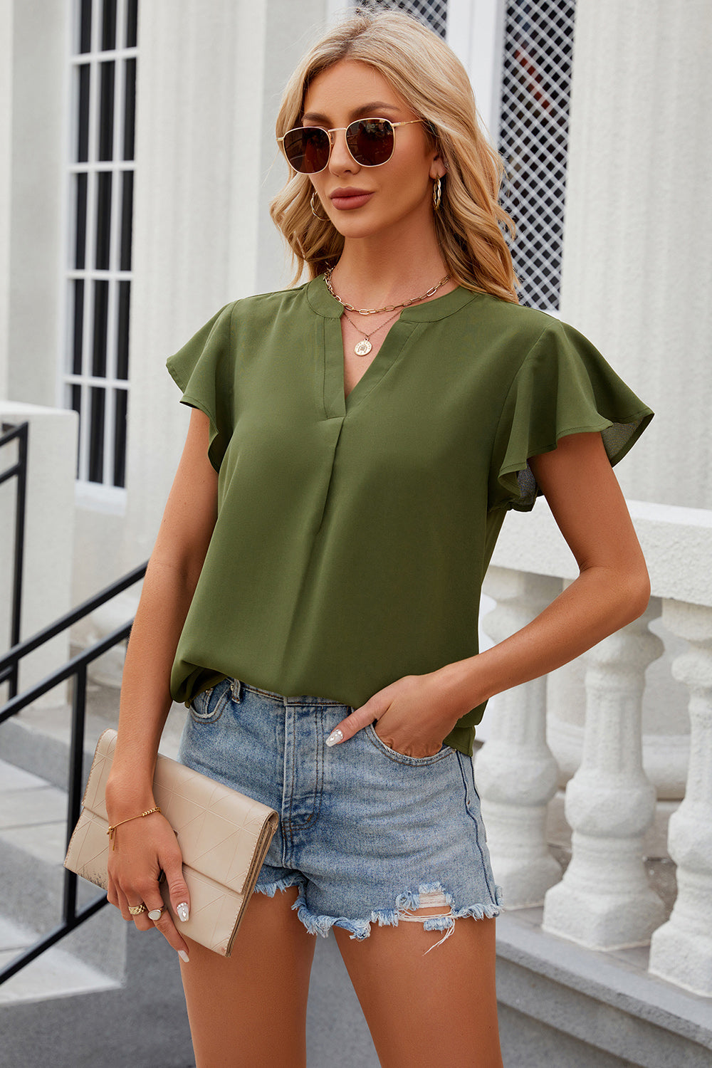 Light green flutter sleeve V-neck blouse with a relaxed fit.