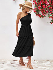 Black smocked bodice one-shoulder tiered midi dress with a flowy skirt.