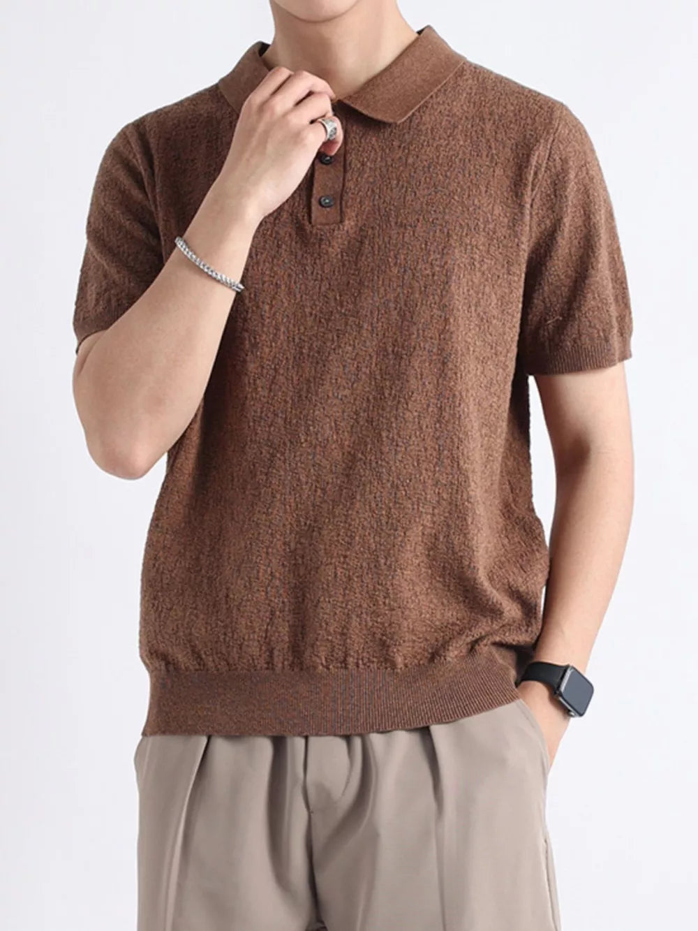 Brown textured short-sleeve polo shirt with button detail and classic collar.