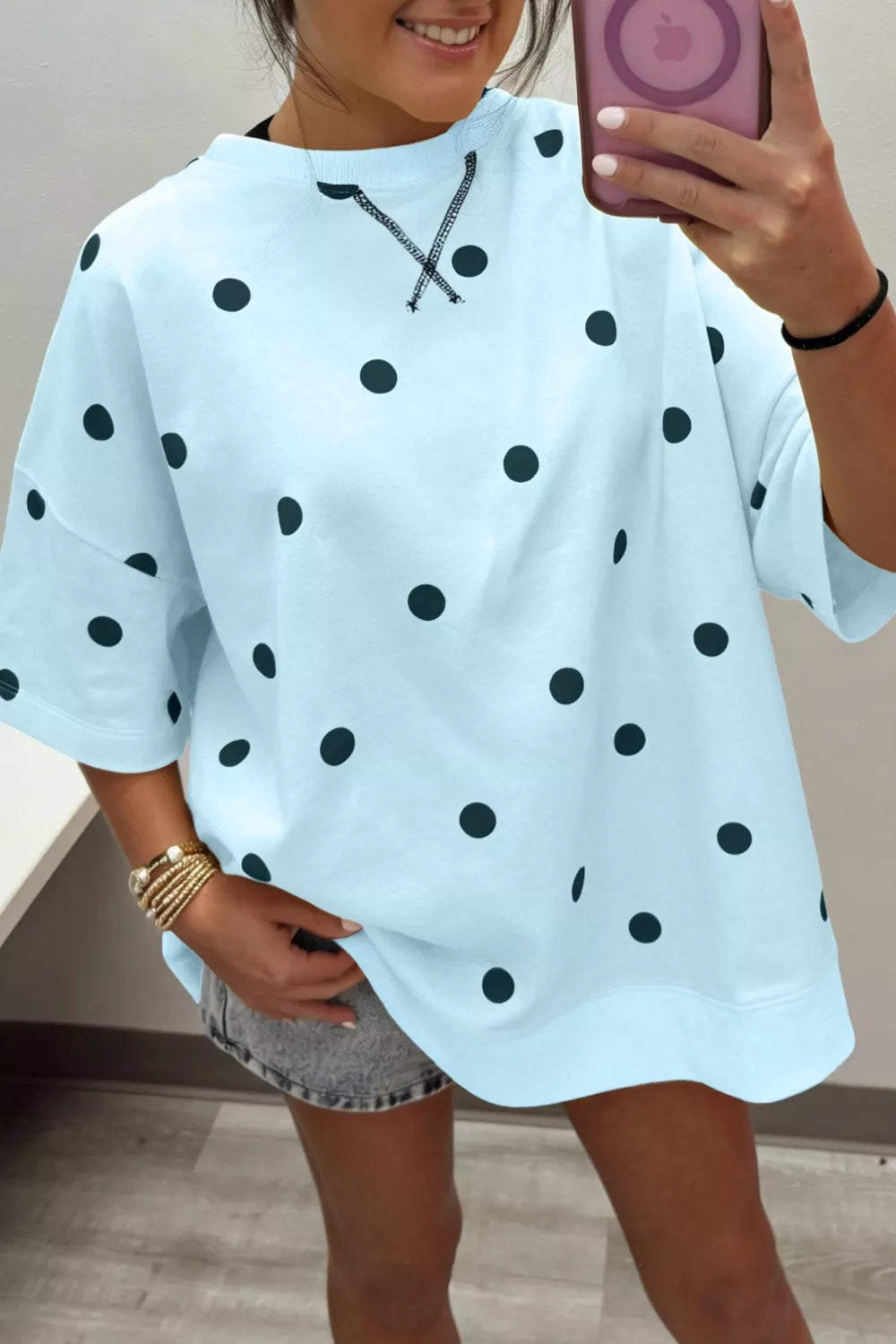 Light blue polka dot oversized t-shirt with cross-stitch detail at neckline.