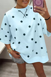 Light blue polka dot oversized t-shirt with cross-stitch detail at neckline.