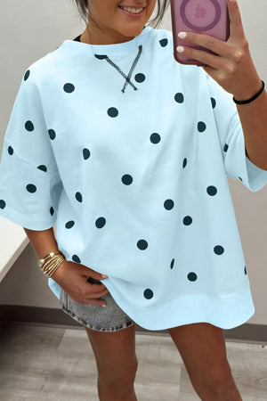 Light blue polka dot oversized t-shirt with cross-stitch detail at neckline.