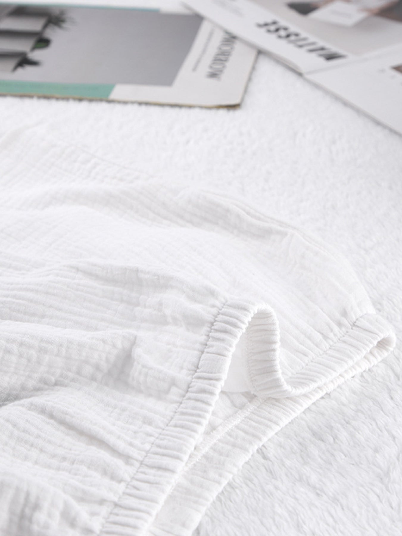 White cotton pajama shorts with textured fabric and elastic waistband