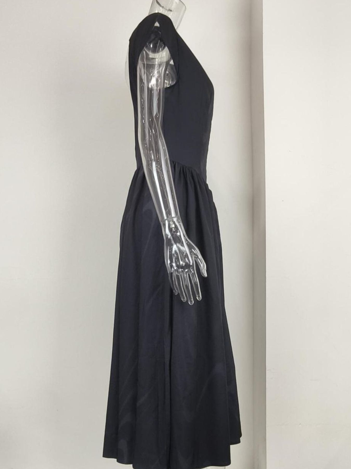 Black cap sleeve a-line midi dress with a boat neck and flowing skirt.