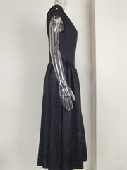 Black cap sleeve a-line midi dress with a boat neck and flowing skirt.