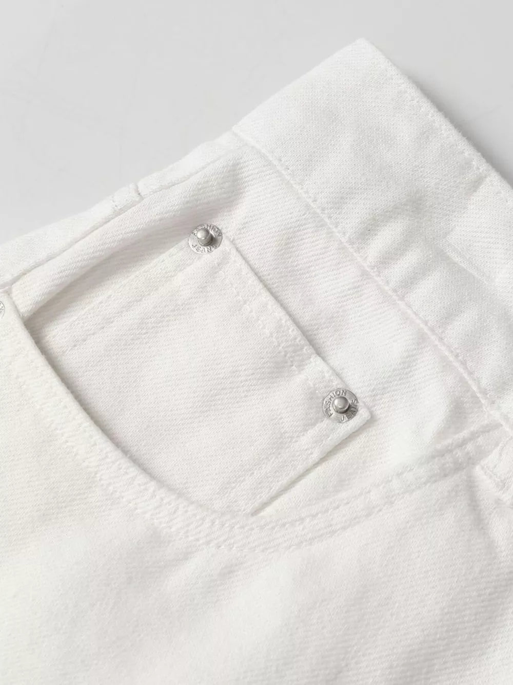 White relaxed fit wide leg sweatpants with silver button details on the pocket.