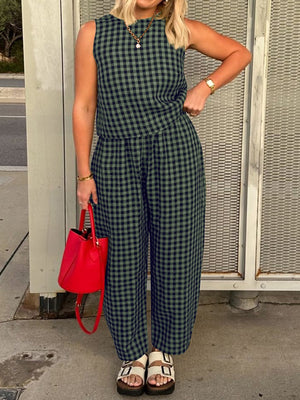 Gingham cropped tank and tapered trousers set in dark green and navy, styled with a red bucket bag.