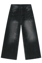 Oversized dark wash denim palazzo trousers with a washed finish and wide leg.