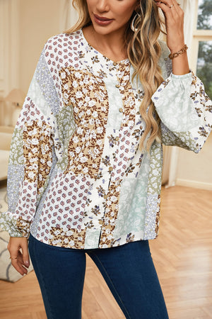 Patchwork floral button-down blouse with balloon sleeves and a round neckline.