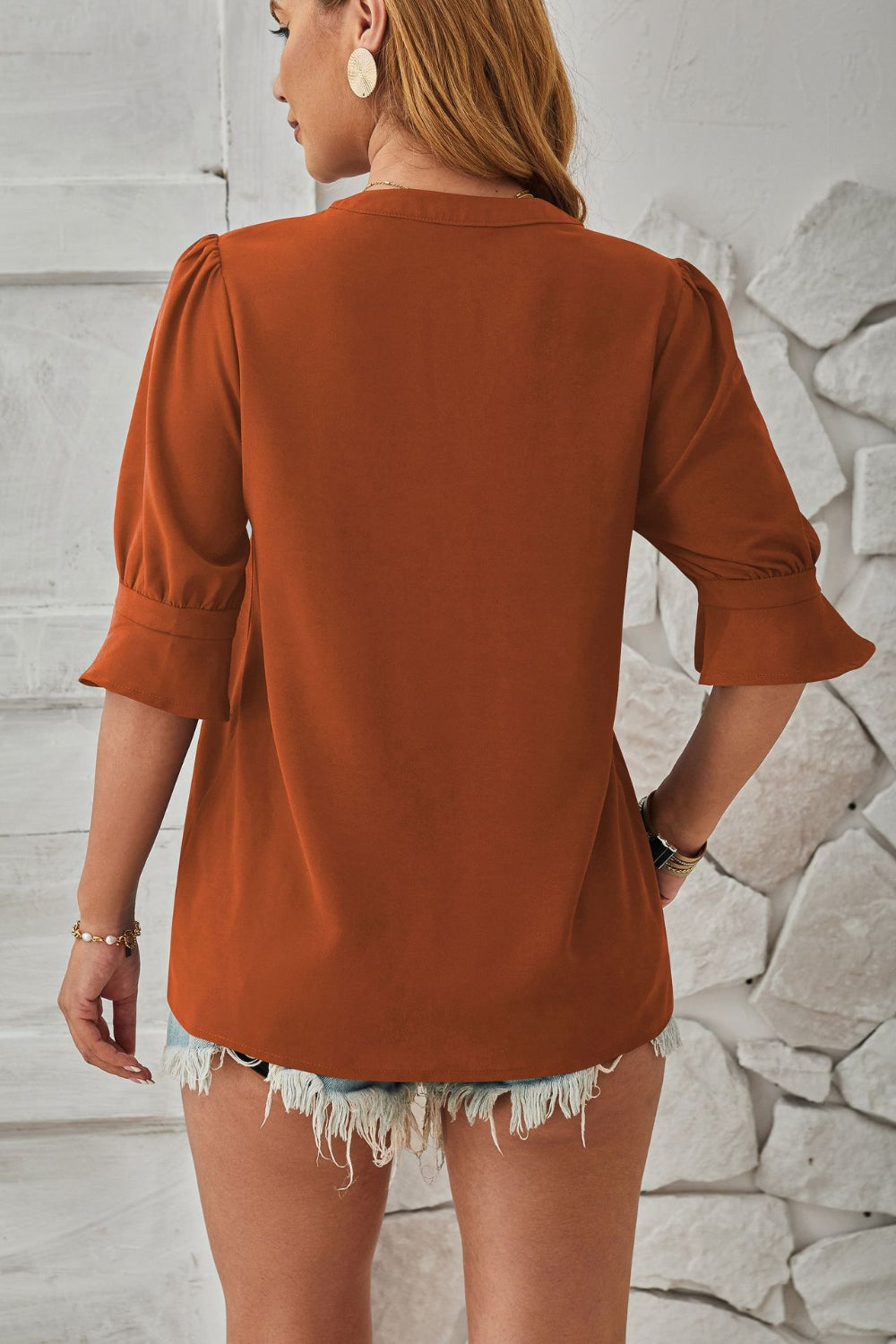 Brown puffed sleeve blouse with flared cuffs and a relaxed fit.