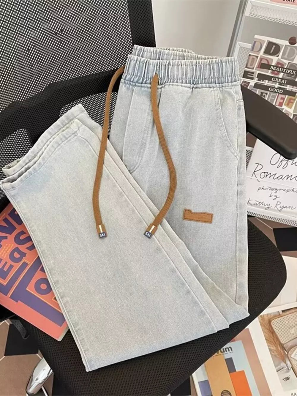 Light blue wide-leg jeans with drawstring and elastic waist.