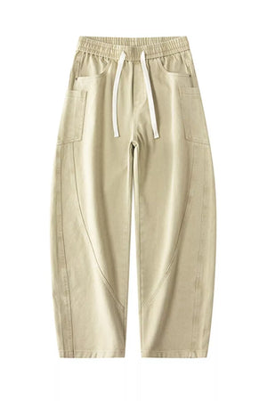 Men's relaxed fit cotton jeans in off-white with drawstring waist and cargo pockets.