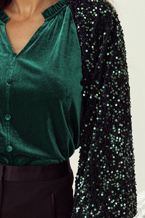 Dark green velvet blouse with ruffled collar and sequin sleeves.