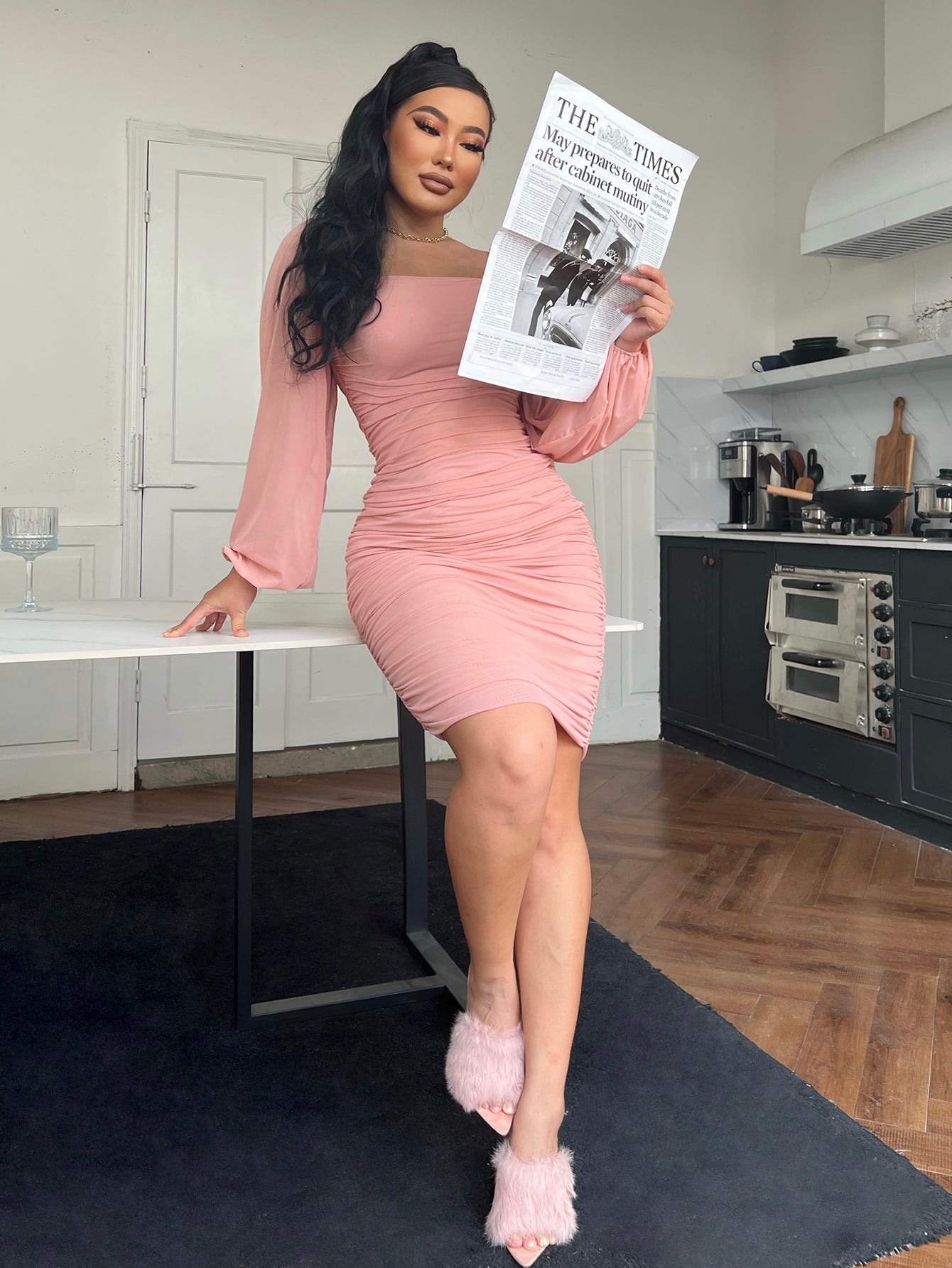 Pink ruched bodycon dress with sheer long sleeves and a square neckline.