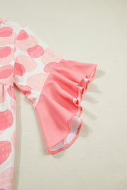 Polka dot babydoll blouse with pink ruffle trim sleeves.
