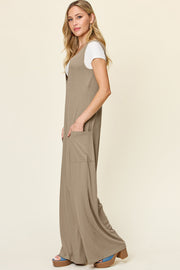 Mocha wide-leg jumpsuit with deep V-neck and front pockets, styled with a white tee.