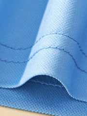 Blue toddler polo shirt fabric detail with visible stitching.