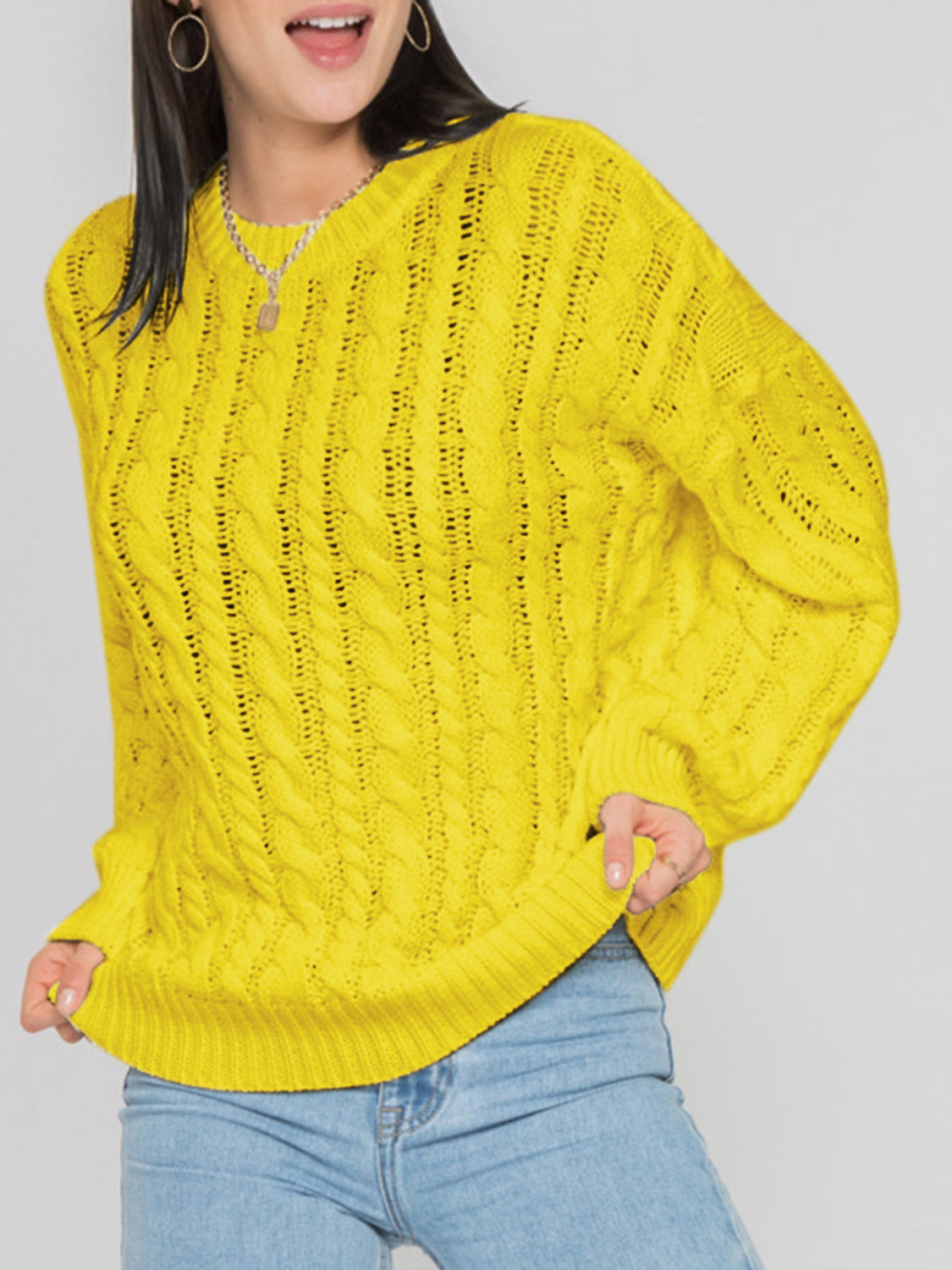 Banana Yellow cable knit openwork sweater with crew neck and long sleeves.