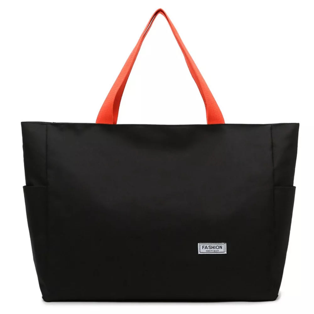 Black canvas shoulder bag with orange straps and side pockets.