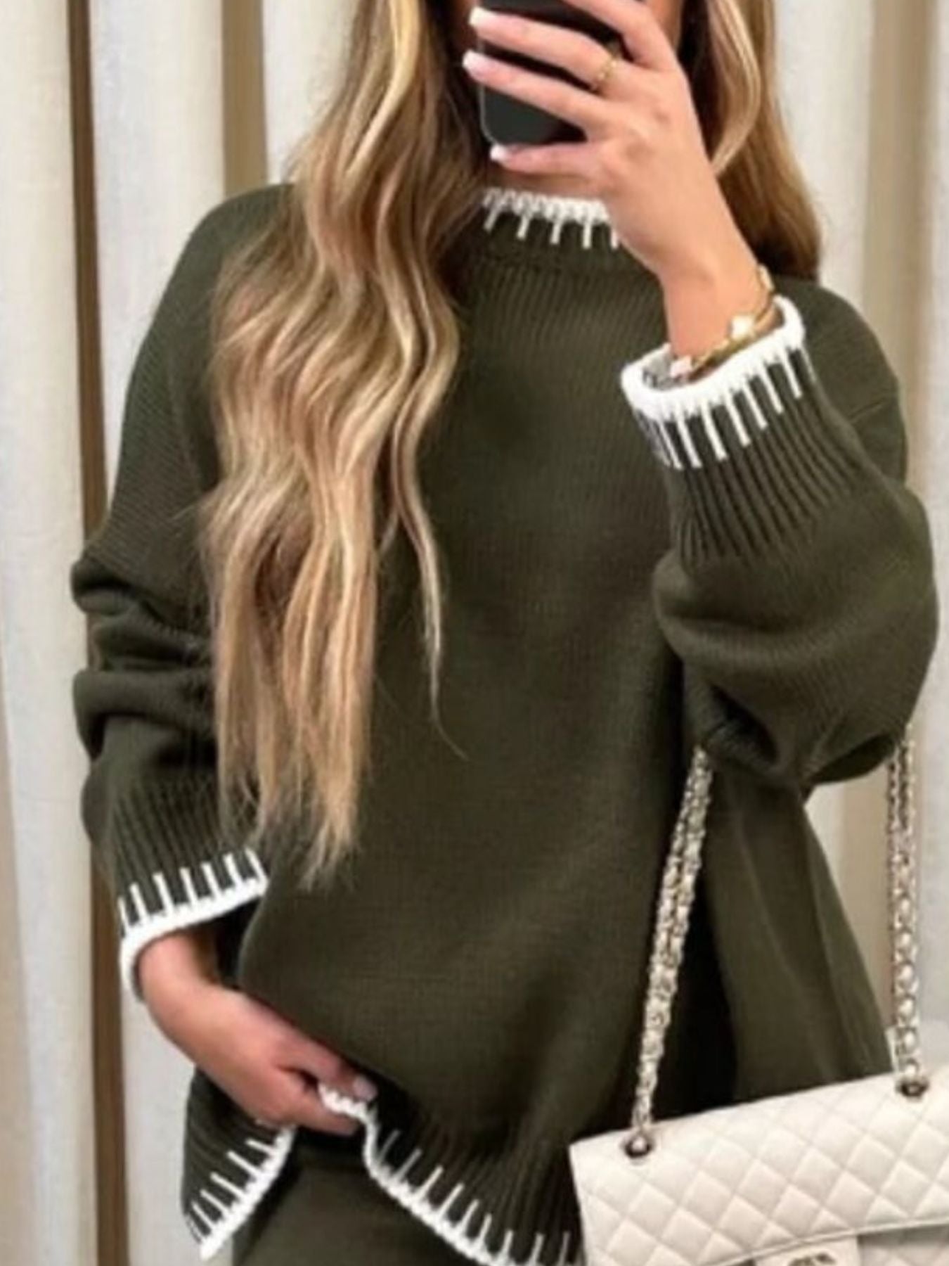 Army green relaxed sweater with white contrast trim on neckline, cuffs, and hem.