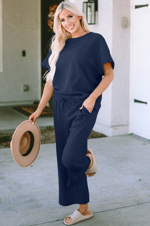 Dark blue textured knit tee and wide leg pants set with drawstring waist and pockets.