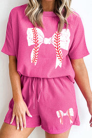 Hot pink waffle knit loungewear set with baseball bow graphic on top and shorts.