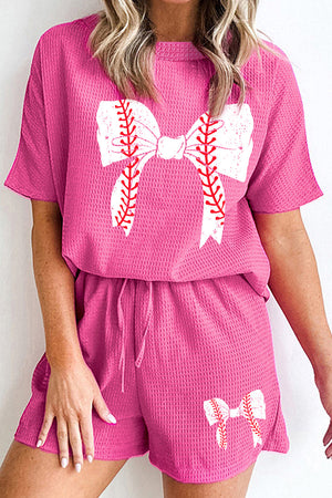 Hot pink waffle knit loungewear set with baseball bow graphic on top and shorts.