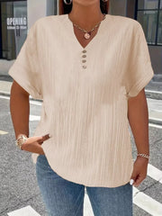 Textured apricot V-neck t-shirt with decorative buttons and short sleeves.