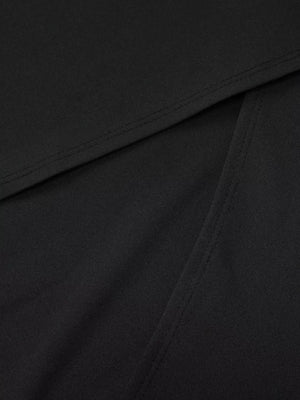 Black maxi dress detail showing seam and fabric texture.