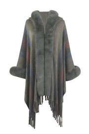 Textured stripe poncho with faux fur trim and fringe detail.