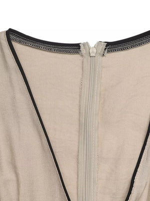 Beige maxi dress with black piping and a zipper detail.