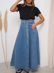 High-waisted A-line denim skirt in light blue with a tie belt and pockets.