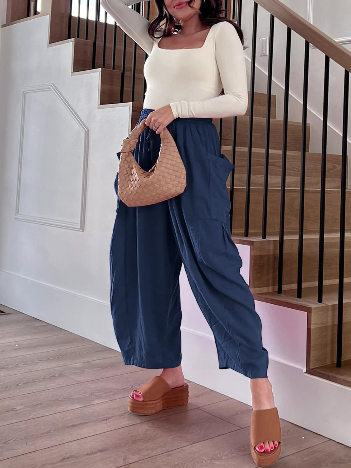 Navy linen balloon trousers with cargo pockets and a relaxed fit.