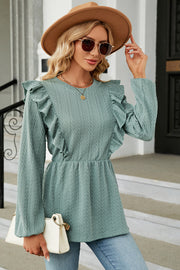 Light blue textured peplum blouse with ruffle details and long sleeves
