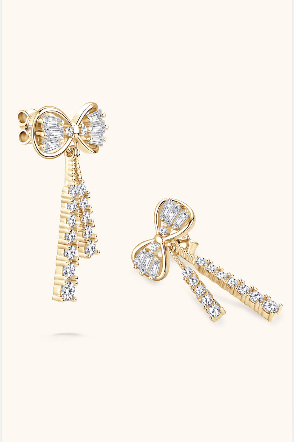 Gold baguette bow drop earrings with diamond accents