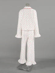 White cotton pajama set with red hearts, ruffled cuffs, and collar trim.