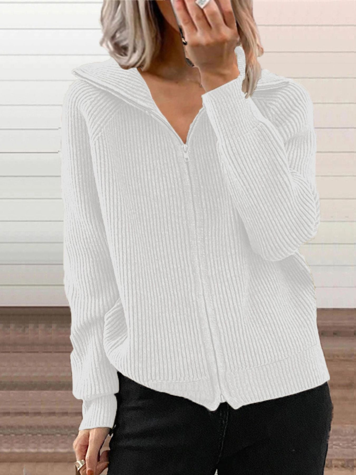 White ribbed knit zip-front trench coat with collar detail.