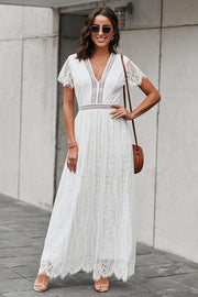 White lace midi dress with scalloped hem and short sleeves.