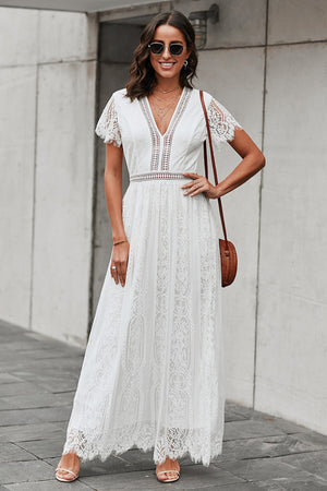 White lace midi dress with scalloped hem and short sleeves.