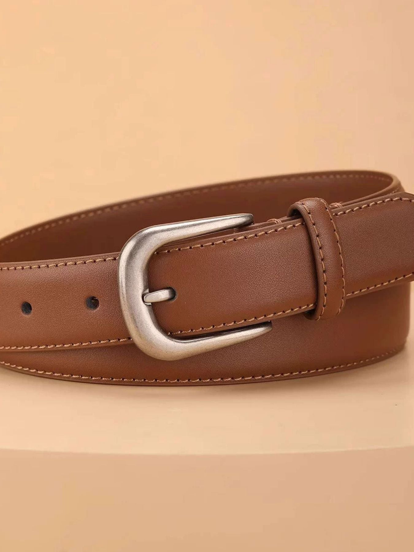 Brown cowhide leather belt with silver buckle and contrast stitching.